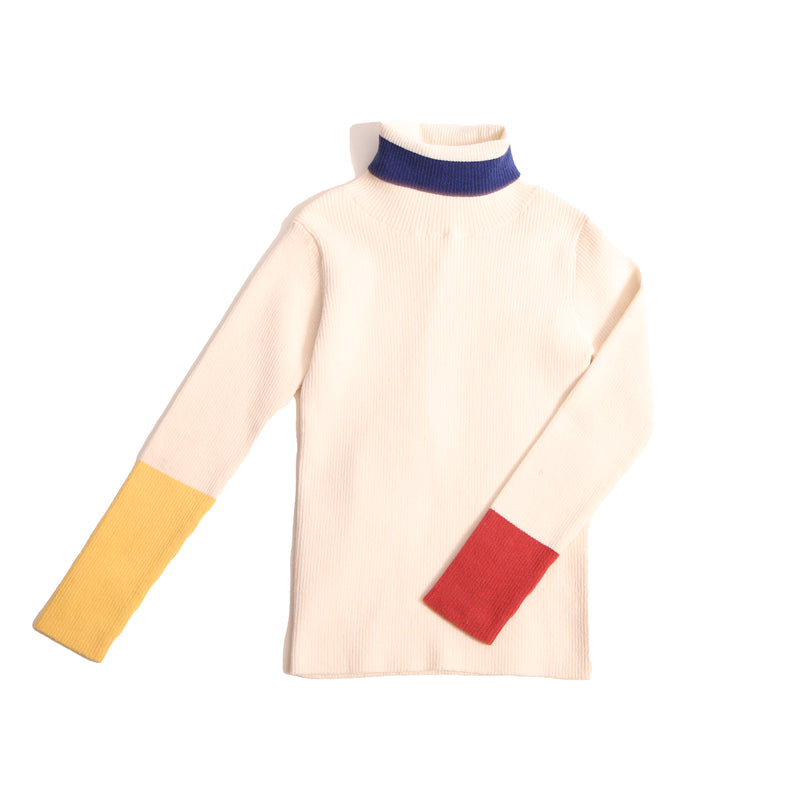 Slim fit, all-over ribbed turtleneck featuring colorblocking and contrast patchwork detailing at sleeves and neckline in this season's fine knit yarn colors. Ideal for wearing alone or as a layering piece in chilly seasons. Opal mix, Tia Cibani.