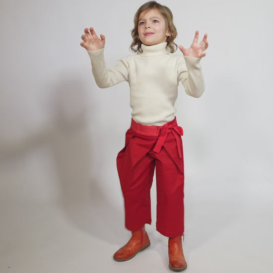 Girl wearing a charming volume topper jacket in soft Chamois Cotton Twill with contrasting lace embellishments, Red and White, Tia Cibani.